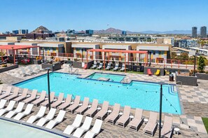 A rooftop pool area with multiple lounge chairs and a swimming pool. - Boulevard Stays Modern Tempe 2BR ASU Pool, Gym (Tempe)