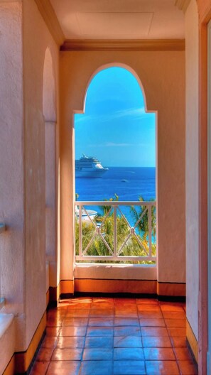 A corridor with a view of the ocean and a cruise ship. - Pueblo Bonito Rose Junior suite in vibrant Cabo San Lucas on the beach! (Cabo San Lucas)