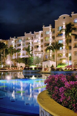 A hotel with multiple balconies, a swimming pool, and tropical landscaping. - Pueblo Bonito Rose Junior suite in vibrant Cabo San Lucas on the beach! (Cabo San Lucas)
