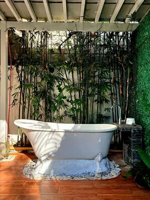 A freestanding bathtub in a covered outdoor area with bamboo plants and a green wall. - Green Villa Private Resort Tropical Luxury, Private Pool & Nature Escape (Cavite)