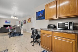 A modern kitchen with wooden cabinets, a microwave, and a toaster. - Aladdin Themed Condo Near Base and the Beach (Biloxi)