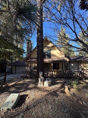 A two-story house with a porch, surrounded by trees. - Enjoy an Escape at Big Bear Lake (Big Bear Lake)