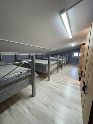 A dormitory room with bunk beds, a wooden wardrobe, and a window. - KADIKÖY MERKEZDE (İstanbul)