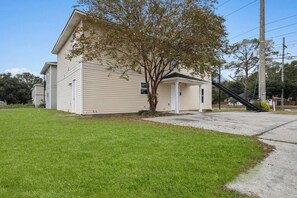 A single-story house with a front porch, a small tree, and a clear sky. - Dreamworks Themed Beach Escape (Biloxi)