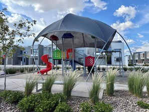 A playground with a covered play area, including slides and climbing structures. - New Listing (Juárez)