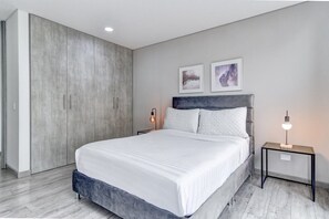 A modern bedroom with a large bed, two bedside tables with lamps, and artwork on the wall. - New Listing (Bogotá, D.C.)