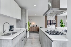A modern kitchen with a central island, stainless steel appliances, and a minimalist design. - New Listing (Bogotá, D.C.)