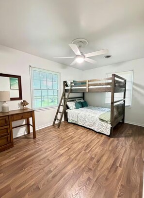 A room with a bunk bed, a desk, a chair, a ceiling fan, and a window with blinds. - Peaceful Family Home . Minutes from Beaches & Attractions (Fort Walton Beach)