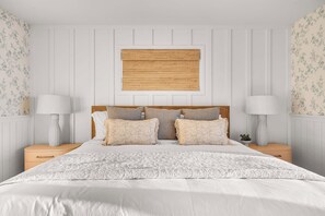 A bedroom with a bed, two bedside tables, a headboard, and a wall-mounted artwork. - Oceanfront Villa with Panoramic Sunset Views! (Encinitas)