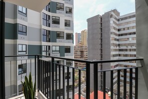 A balcony with a view of adjacent high-rise buildings. - w* | Chic 1BR w/ Balcony in Miraflores (Miraflores)