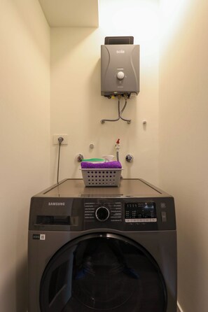 A Samsung washing machine with a control panel and a basket of laundry on top. - w* | Fantastic 2BR with Balcony in Miraflores (Miraflores)