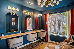 A room with a vanity area, mirrors, a neon sign, a window with curtains, and a view of the outdoors. -     10-Acre Resort Ranch & Venue, Pool, Hot Tub, Game Barn, Theater Sleeps 30 (Wimberley)