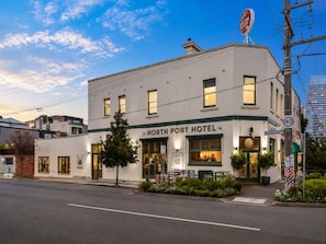 A two-story building with a sign reading 'NORTH PORT HOTEL'.