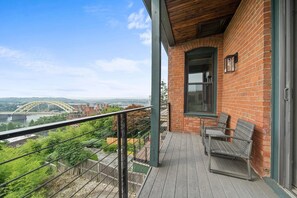 Ein Balkon mit Blick auf eine Brücke und Stadtlandschaft.