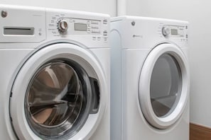 Two front-loading washing machines with control panels. - Glacier Canyon  Wilderness Waterpark Wisconsin Dells, 2 BR 1,500 sq ft Condo (Baraboo)