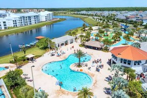 A resort with a large central pool, a marina, and a variety of buildings. - Lake View 2BR Condo Near Disney (Kissimmee)
