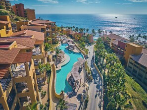 A resort with a pool, palm trees, and a view of the ocean. - 1 bdrm Christmas week in 5 star Grand Fiesta Americana Los Cabos Golf/Spa Resort (Cabo San Lucas)