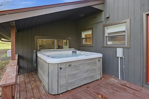 A spa-like hot tub with a wooden exterior, a covered deck, and a windowed entrance. - Wood Pond Lodge - Single Fam Oasis on 3 acres (Middlesex)