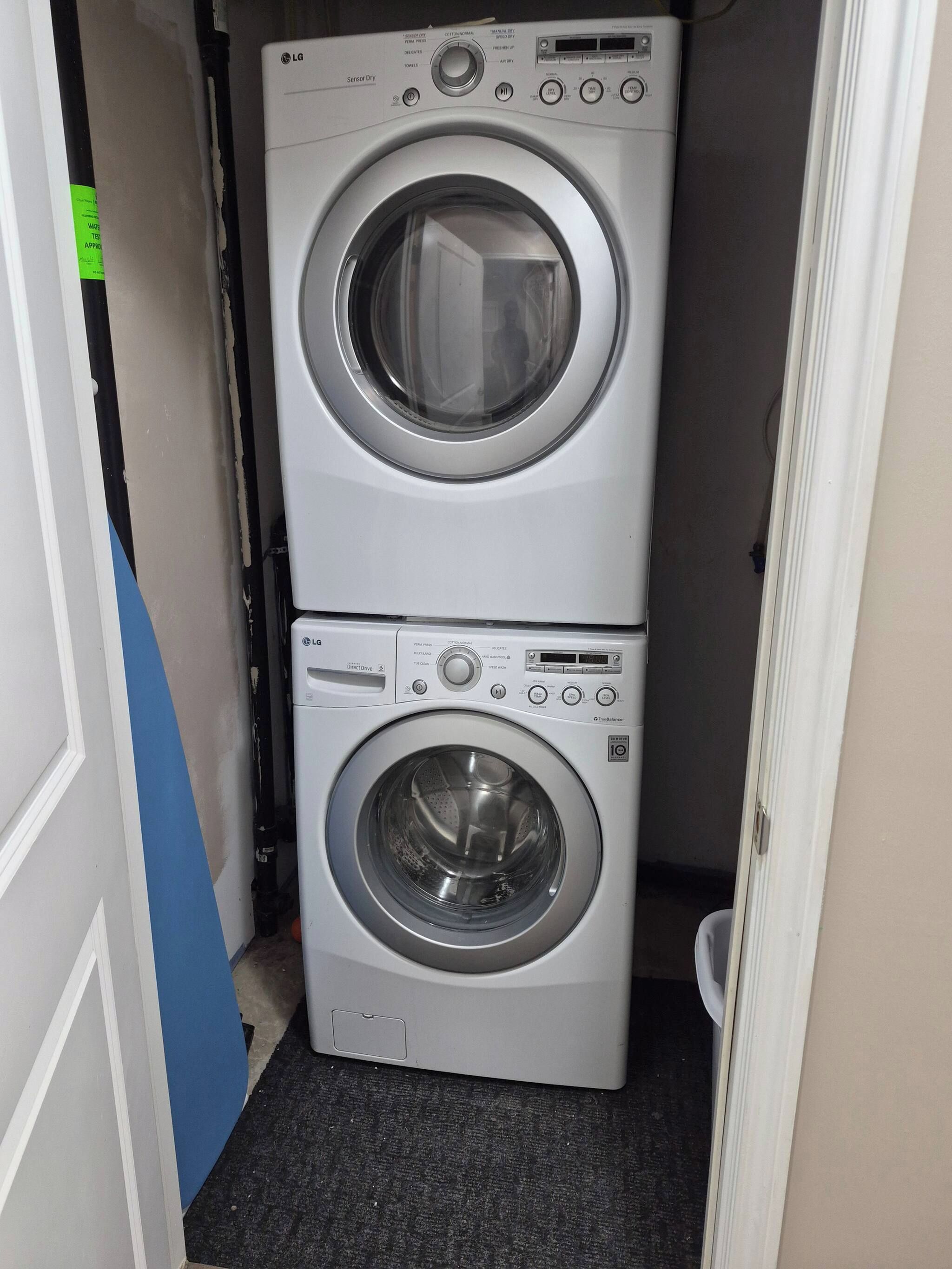 A stacked washer and dryer unit in a laundry room.