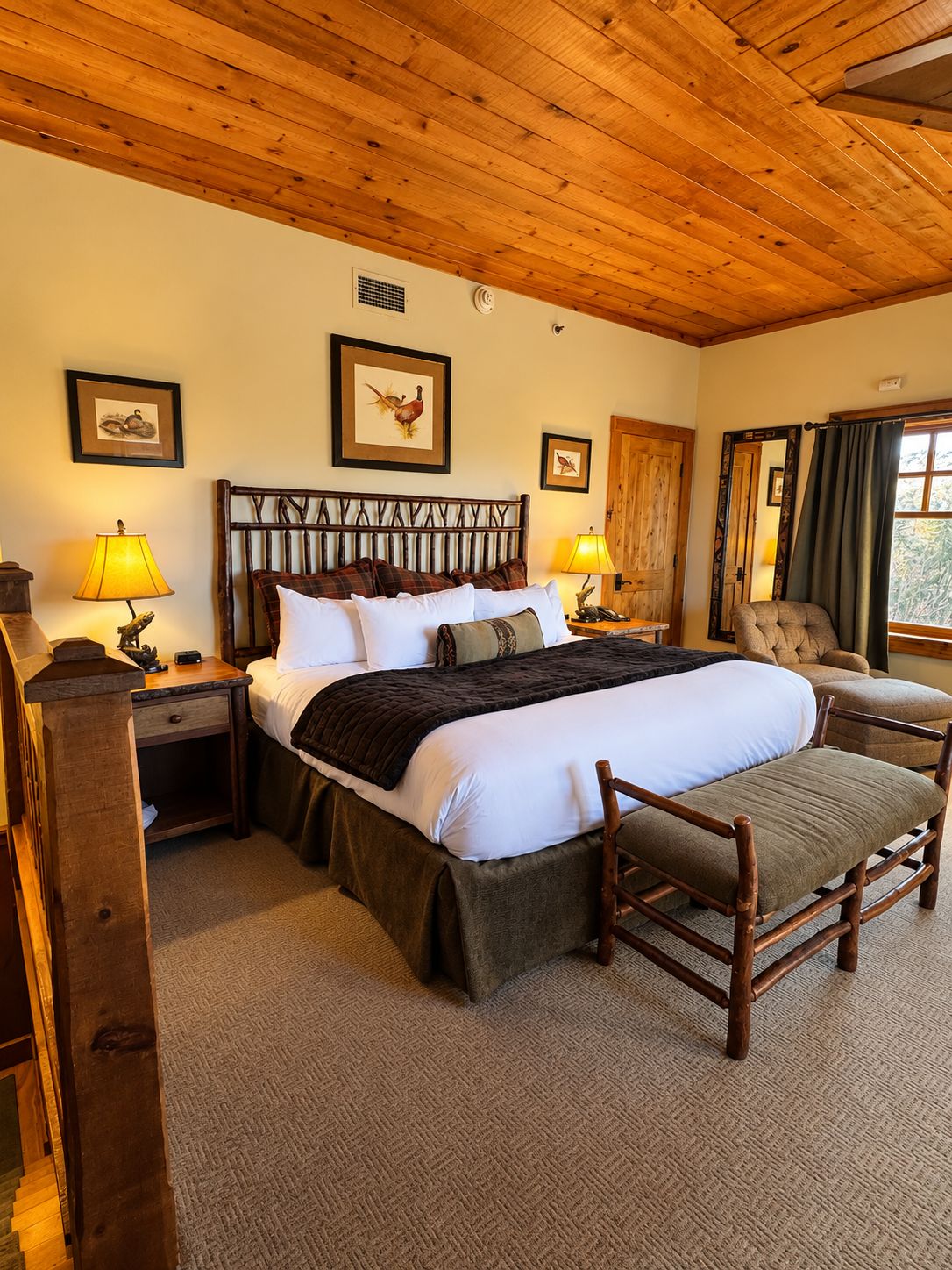 A bedroom with a wooden ceiling, a bed with white bedding, two bedside lamps, a chair, and a mirror.