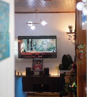A living room with a flat-screen TV mounted on the wall, a wooden entertainment center below, and a ceiling light fixture. - Spacious Family Villa with Private Terrace in Jong-ro / 3 queen bed n 1 bath (Seoul)