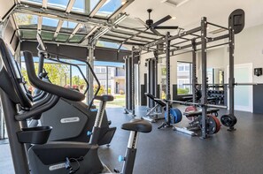 A gym with exercise equipment, including treadmills and weightlifting stations. - Boulevard Stays Tempe 3BR 2BA near ASU, Pool, Gym (Tempe)