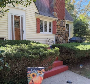 A house with a stone chimney, a covered patio, and a 'hello Fall' sign. - The Serenity Hideaway -3 Bedroom 1 1/2 Bath House (Hinton)
