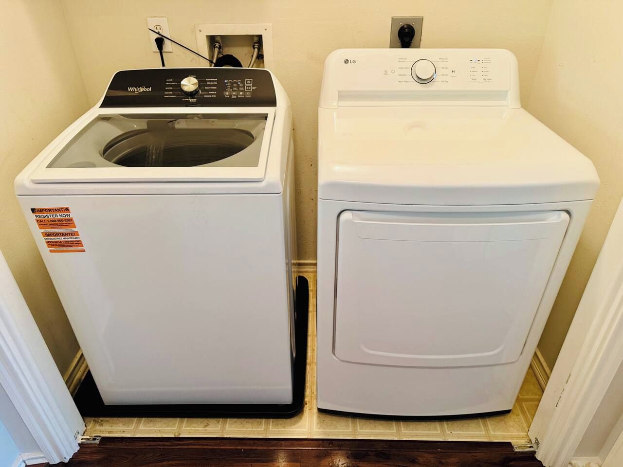 A laundry room with a Whirlpool washer and an LG dryer.