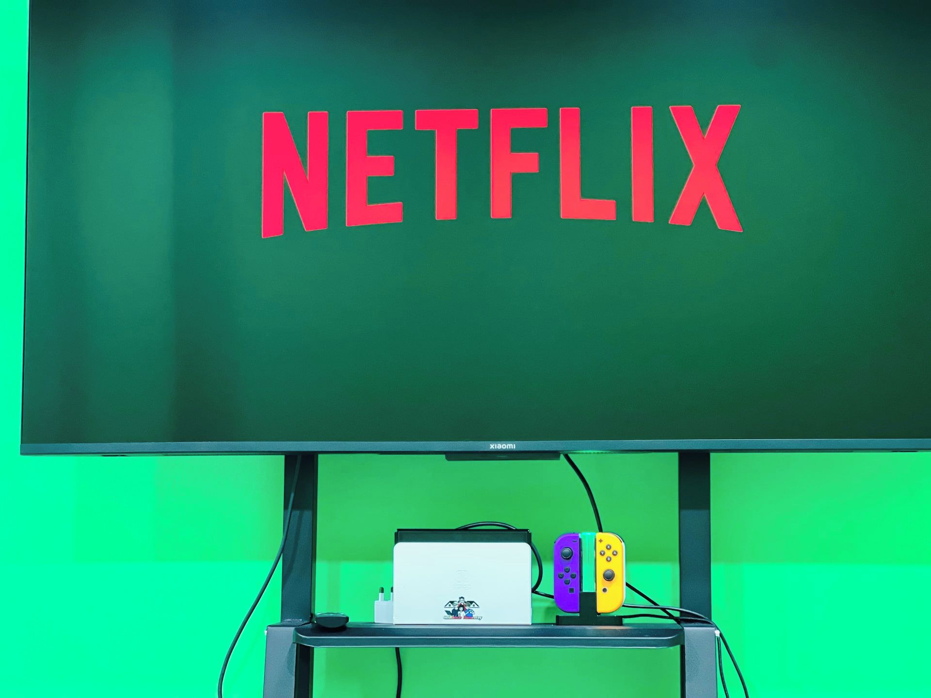 A television with the word 'NETFLIX' displayed on a green background.