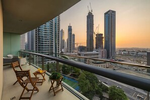 Ein Balkon mit Blick auf eine Stadtlandschaft, darunter Hochhäuser und eine Baustelle.