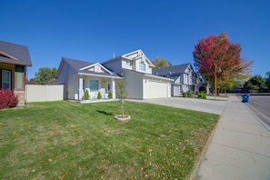 A residential house with a front yard, a driveway, and a street view. - The Boise Retreat | Spacious Home, Game Room! (Boise)