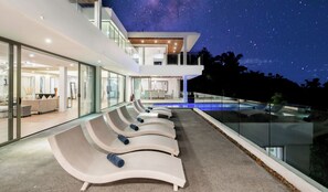 A modern house with a swimming pool, lounge chairs, and a starry night sky. - MoonShadow Villa Phuket (Kathu District)