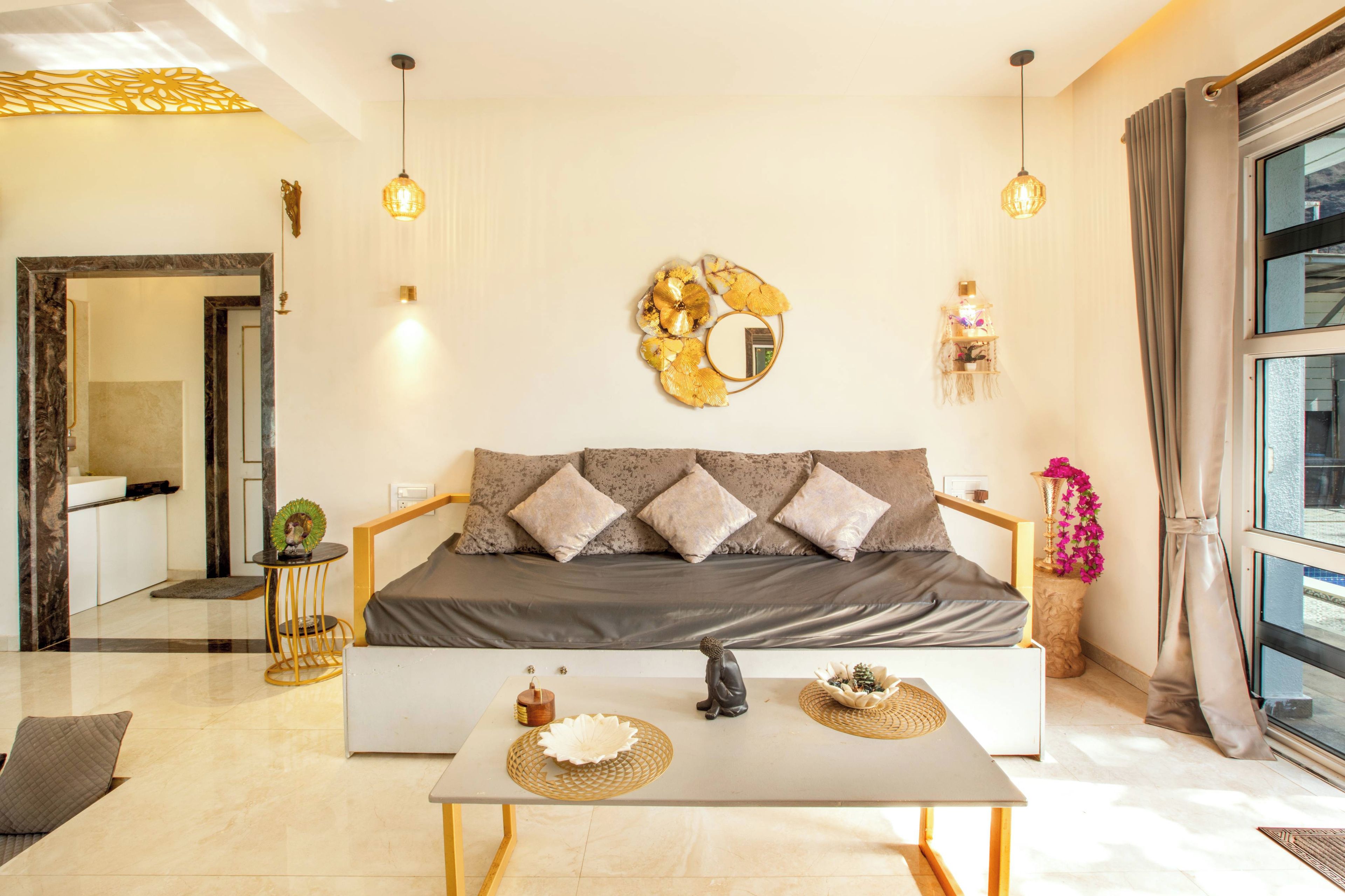 A modern living room with a sofa, a coffee table, and decorative items.