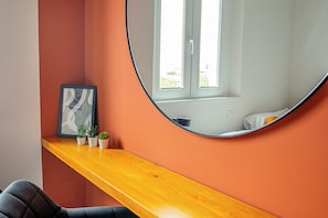 A room with a curved mirror, a wooden desk, and a window with a view of the outdoors. - Comfy and cozy, at a short distance form sea, city centre and train station. (Rimini)