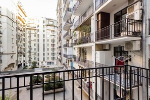 A multi-story residential building with balconies, air conditioning units, and a visible laundry area. - 2 Bedroom Deluxe Apartment In The City Center (Tbilisi)