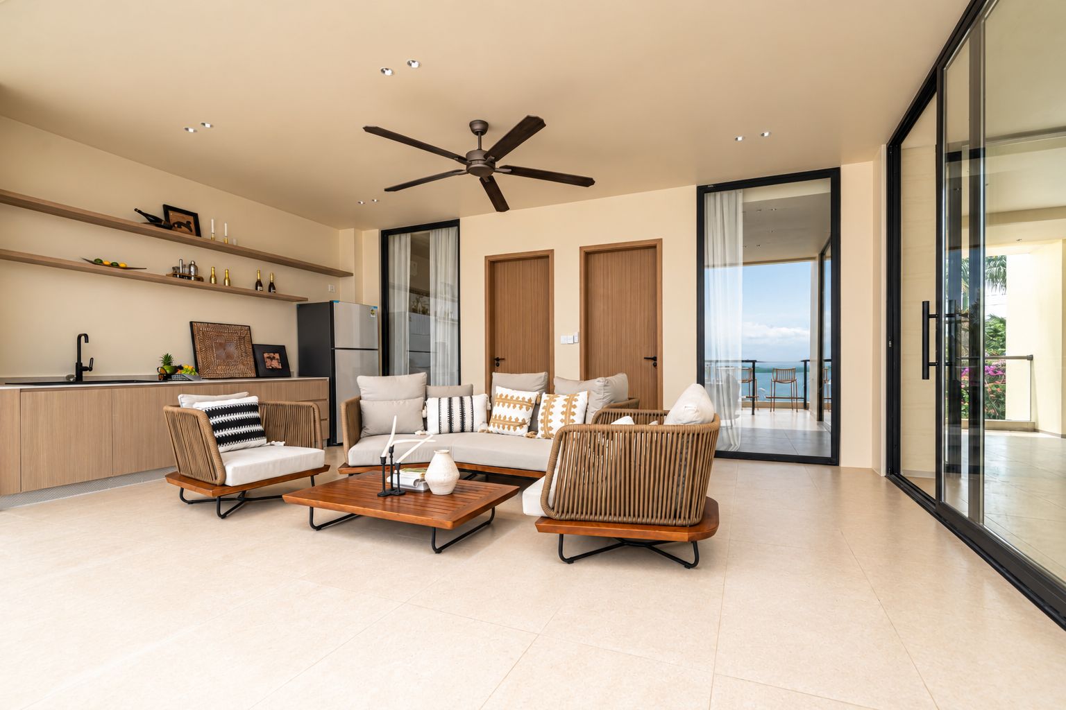 A modern living room with a sofa set, a coffee table, and a ceiling fan.