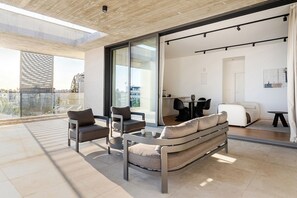 A modern living room with a sofa, chairs, and a dining table. - YAMAS Urban Living Sequoia Residence 3BR Penthouse (Lemesos)