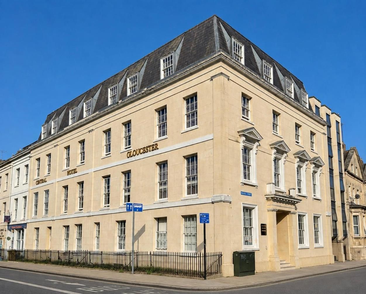 A historic hotel building with a central entrance, multiple windows, and a classic architectural style.