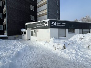 A building labeled 'Sports Tower Fichtenweg 54' with a snow-covered ground. - New Listing (Winterberg)