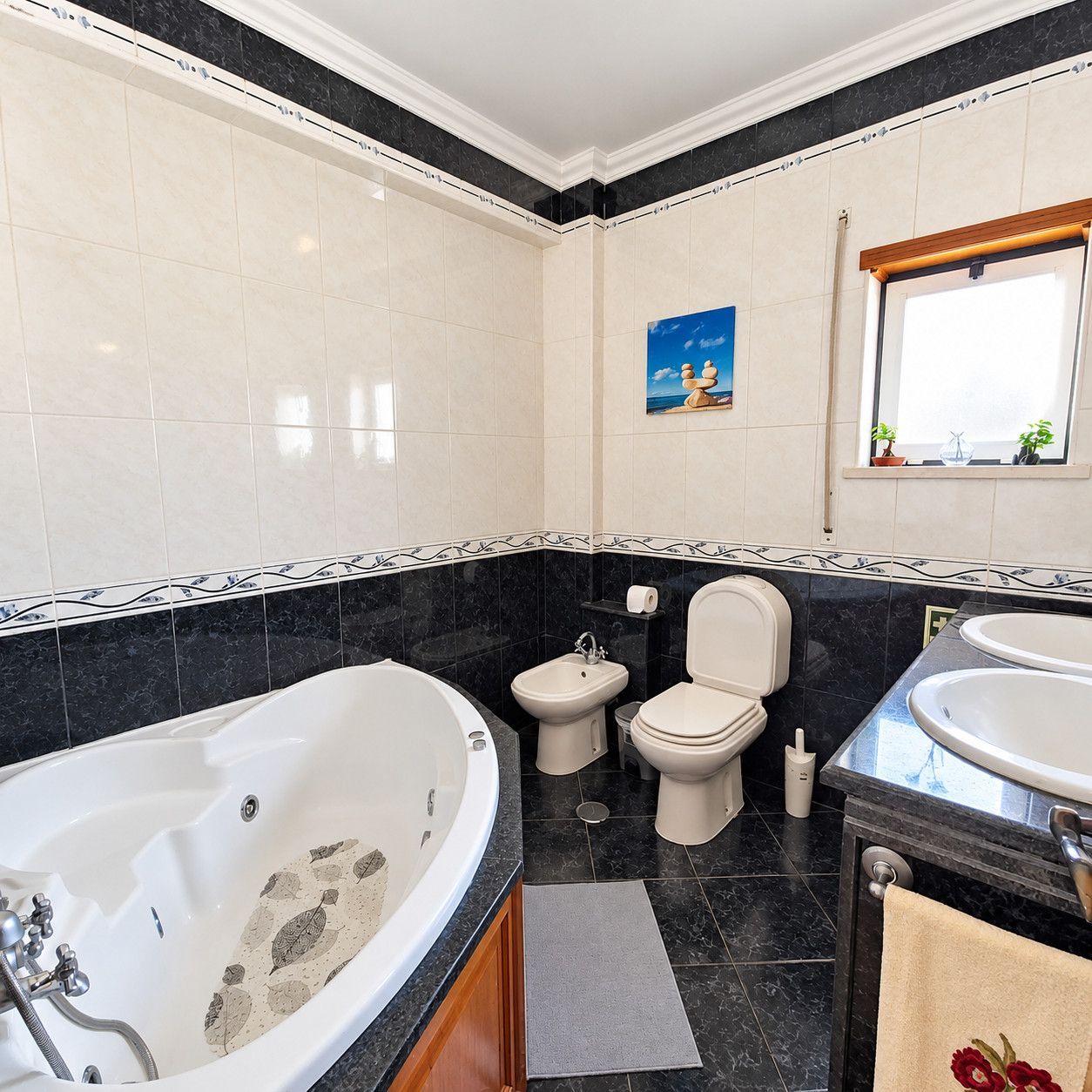 A bathroom with a bathtub, bidet, toilet, and sink.