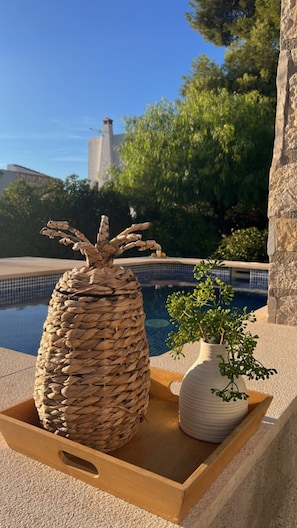 A wooden tray with a woven pineapple sculpture and a white vase with green foliage. - New Listing (El Tosalet)