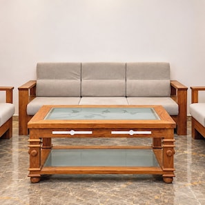 A modern living room with a sofa, wooden coffee table, and matching side tables. - StayGuru Kutch Shahi Haveli (Bhuj)
