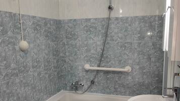 A bathroom with a bathtub, a toilet, and a sink.