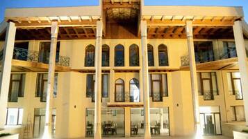 A multi-story building with a central atrium, large windows, and balconies.