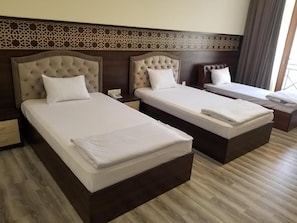 A hotel room with two beds, a nightstand, and a window with curtains. - Grand Ark Bukhara (Bukhara)
