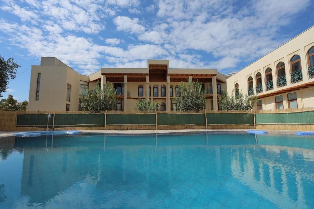 A swimming pool with a building in the background.