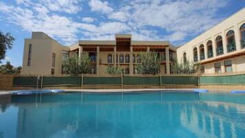 A swimming pool with a building in the background.