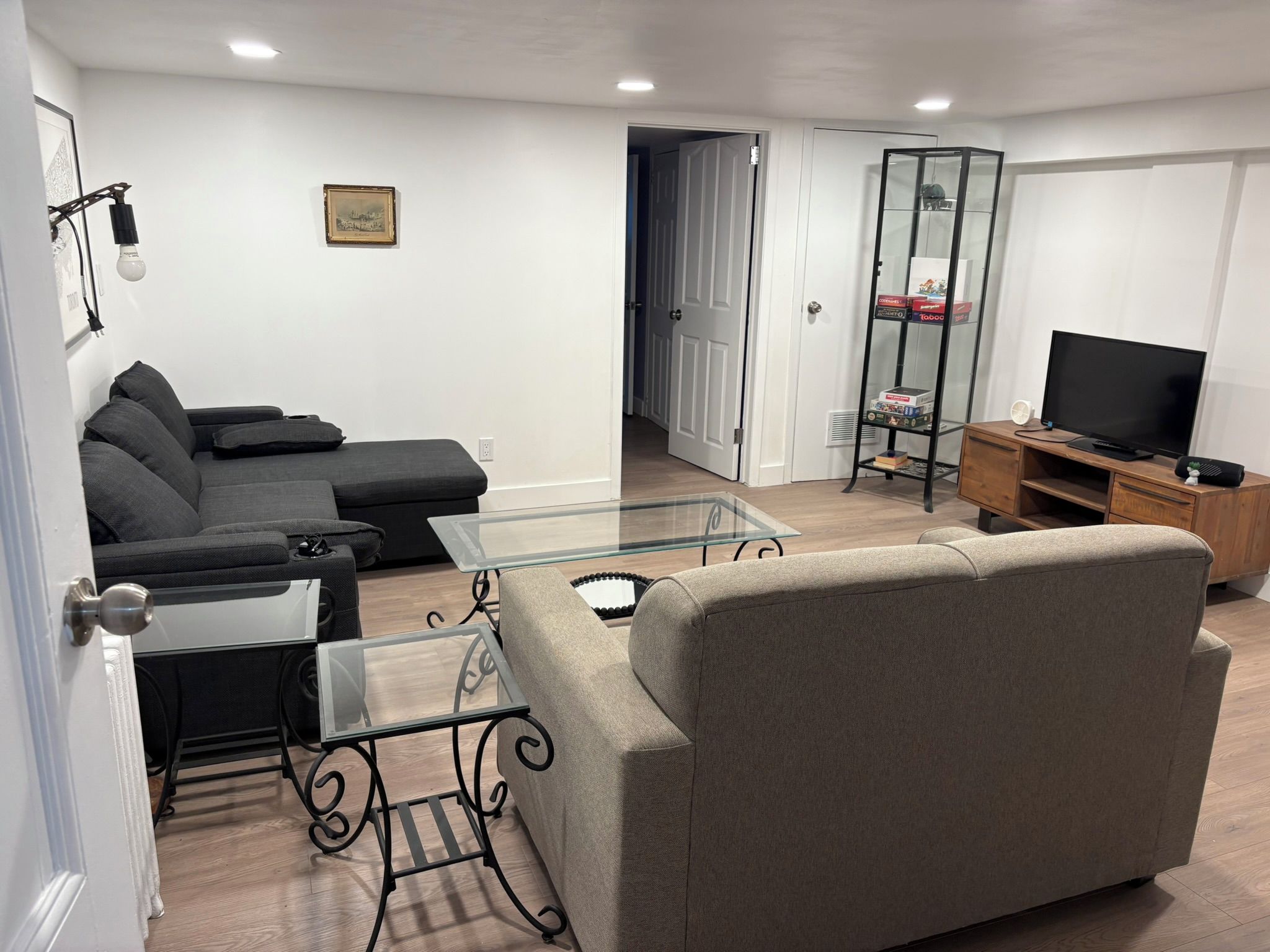 A living room with a sofa, coffee table, and TV stand.