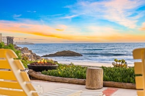 A beachside seating area with a fire pit, overlooking the ocean and a rocky shoreline. - Toes On The Sand, Perfect 4 Families, Amazing View (Ventura)