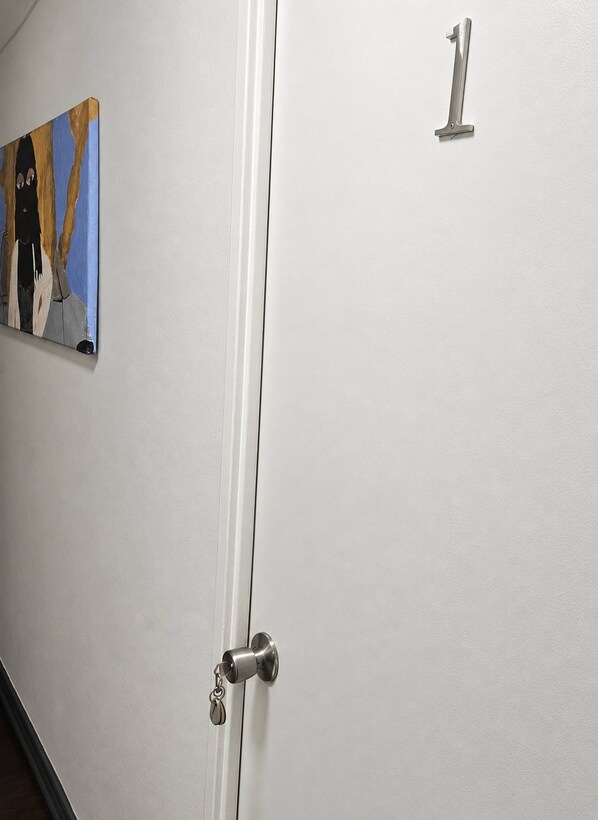 A door with a keyhole and a number '1' sign above it.